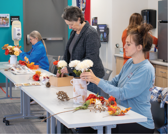 Adults making a craft.
