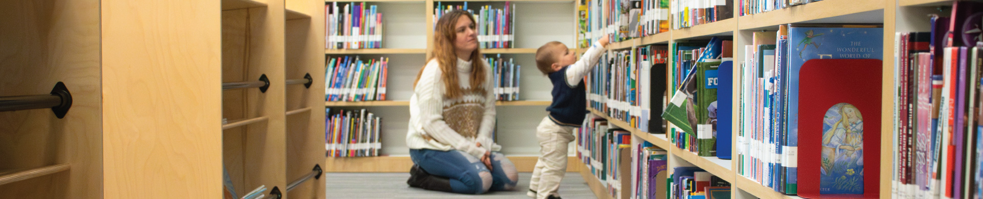 Parent with child in library